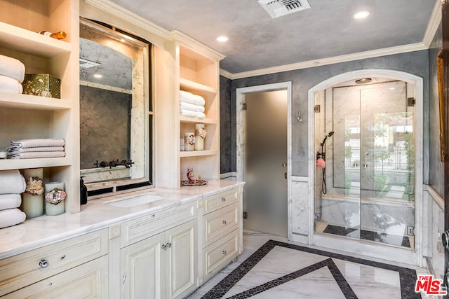 bathroom featuring built in shelves, ornamental molding, and vanity