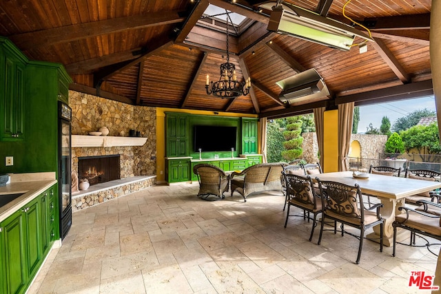 view of patio / terrace featuring a gazebo and an outdoor stone fireplace