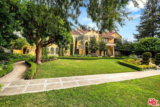 mediterranean / spanish house with a front lawn