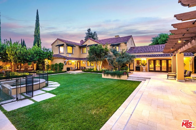 yard at dusk with a patio area and a pergola