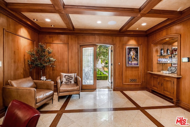 foyer entrance featuring coffered ceiling, french doors, beamed ceiling, and wood walls