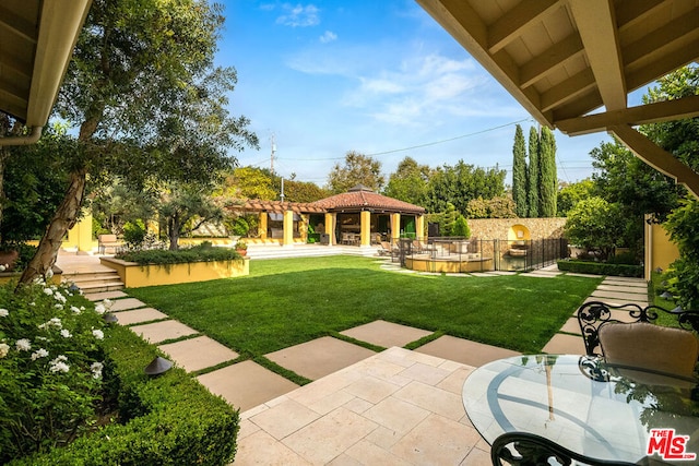 view of yard featuring a gazebo and a patio area