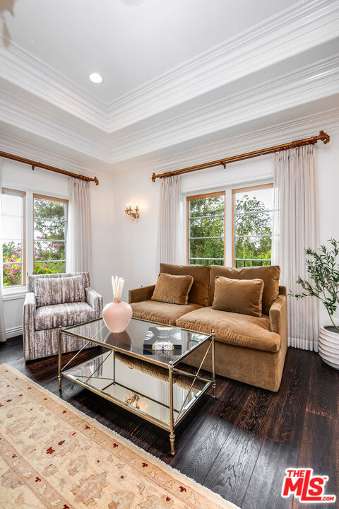 living room with ornamental molding and wood-type flooring