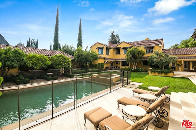 view of pool featuring a patio, a water view, a yard, and an in ground hot tub