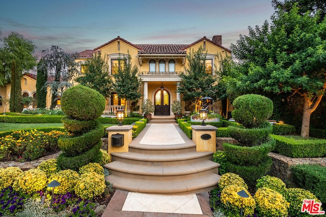 mediterranean / spanish-style house with french doors