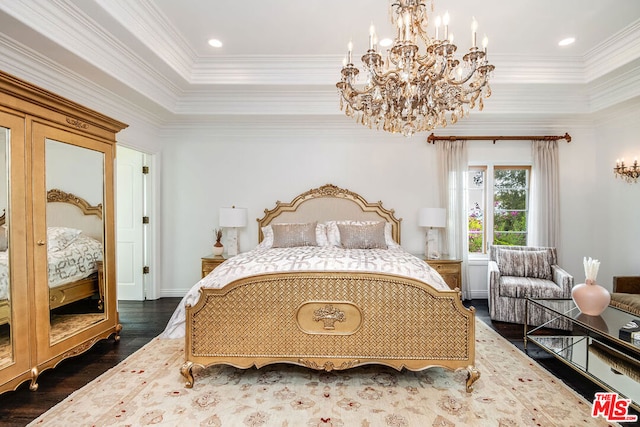 bedroom with crown molding, dark hardwood / wood-style floors, an inviting chandelier, and a tray ceiling