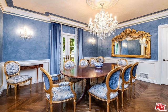 dining room featuring dark parquet flooring, ornamental molding, and a chandelier