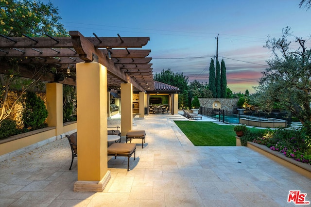 patio terrace at dusk with a pergola