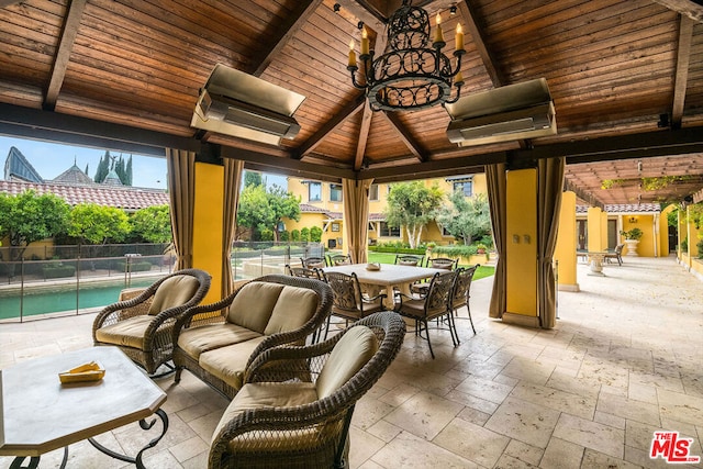 view of patio / terrace featuring a fenced in pool and a gazebo