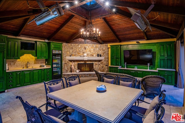 view of patio with a gazebo, sink, and an outdoor stone fireplace