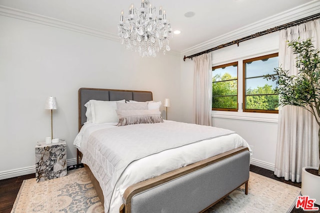 bedroom featuring hardwood / wood-style floors, crown molding, and a chandelier