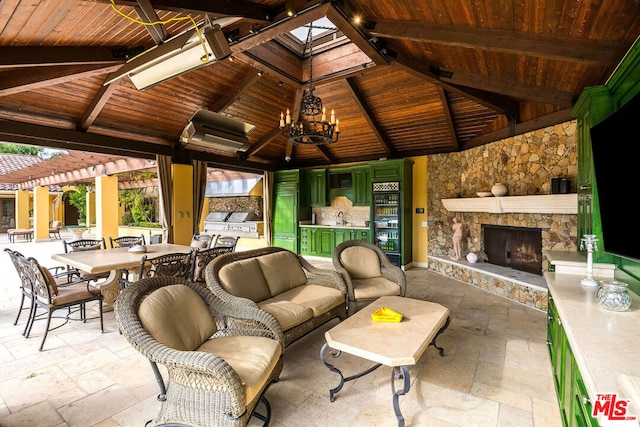 view of patio / terrace featuring a gazebo, ceiling fan, and an outdoor living space with a fireplace