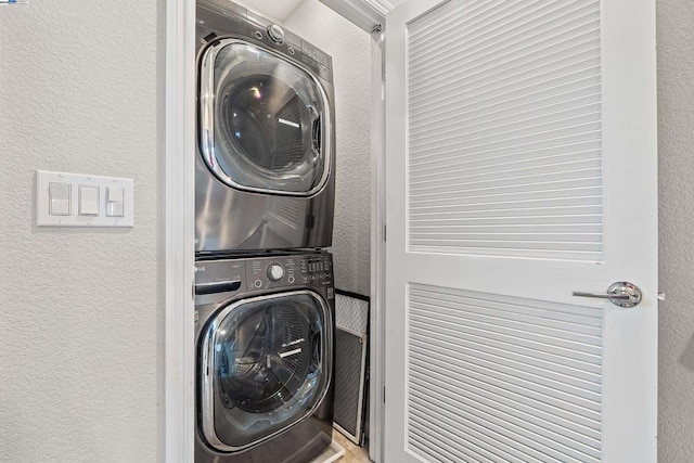 clothes washing area with stacked washer and dryer