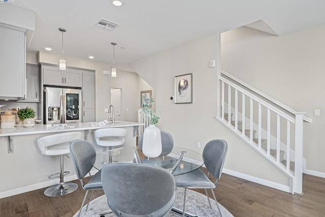 dining room featuring dark wood-type flooring and sink