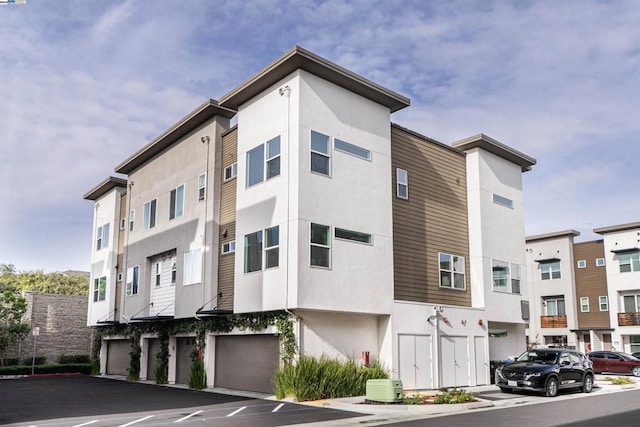 view of building exterior featuring central AC and a garage