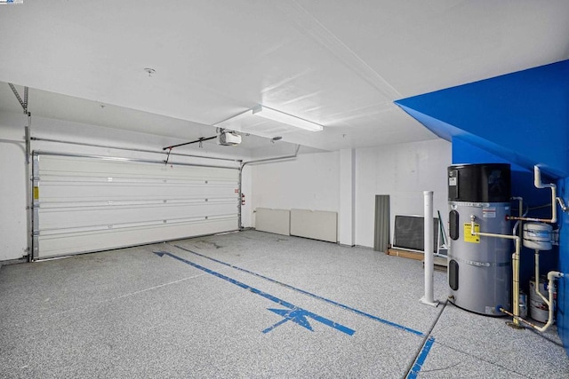 garage with a garage door opener and secured water heater