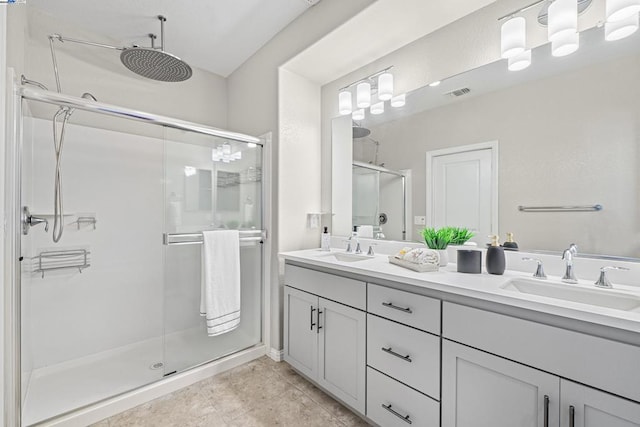 bathroom featuring vanity, tile patterned floors, and a shower with shower door