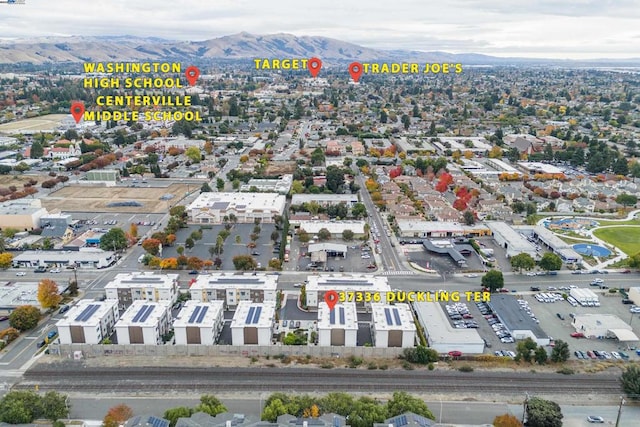 birds eye view of property featuring a mountain view