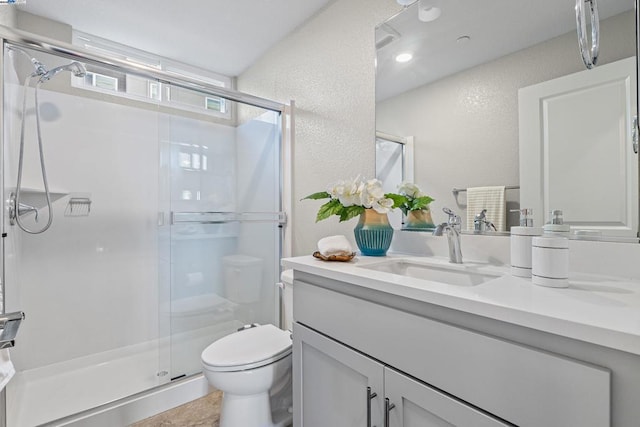 bathroom featuring vanity, toilet, and an enclosed shower