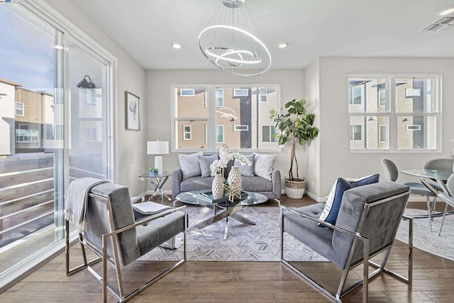 living room featuring hardwood / wood-style flooring and a chandelier