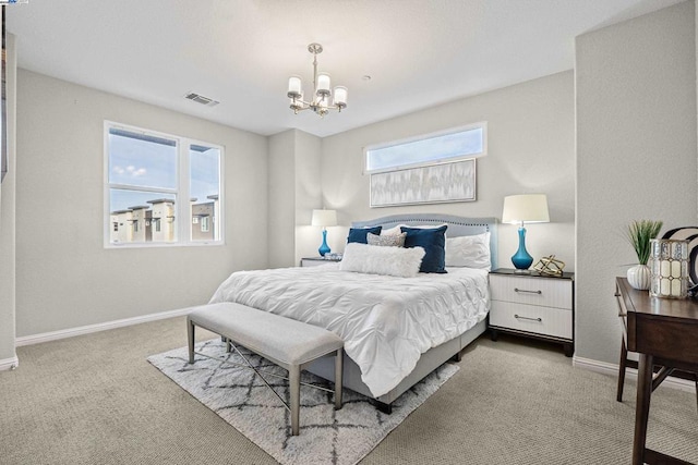 bedroom featuring a chandelier and light carpet