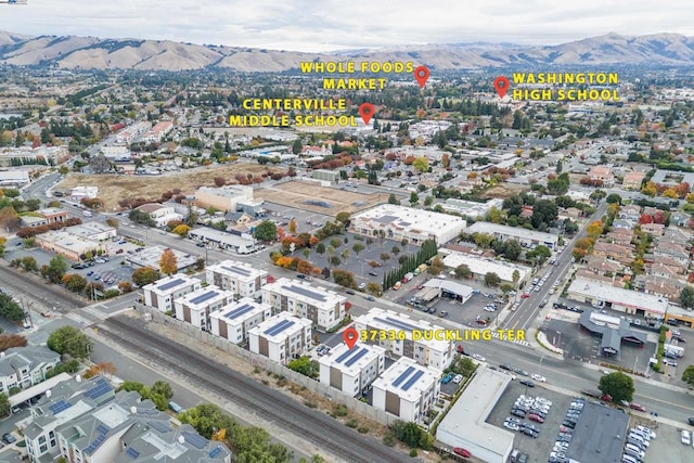 birds eye view of property featuring a mountain view