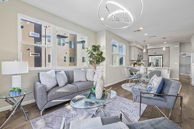 living room featuring hardwood / wood-style flooring and a notable chandelier