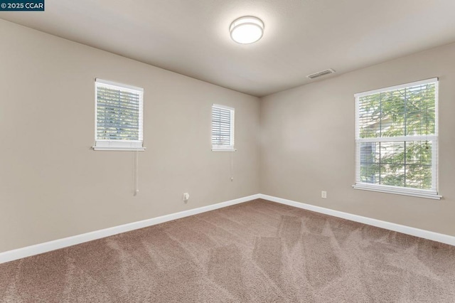 unfurnished room featuring carpet