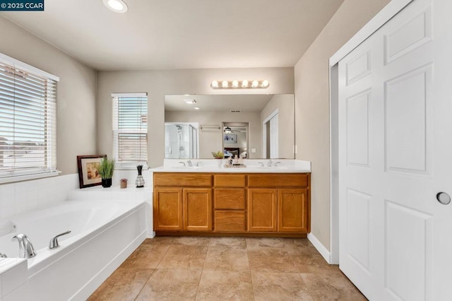 bathroom with tile patterned floors, vanity, and independent shower and bath