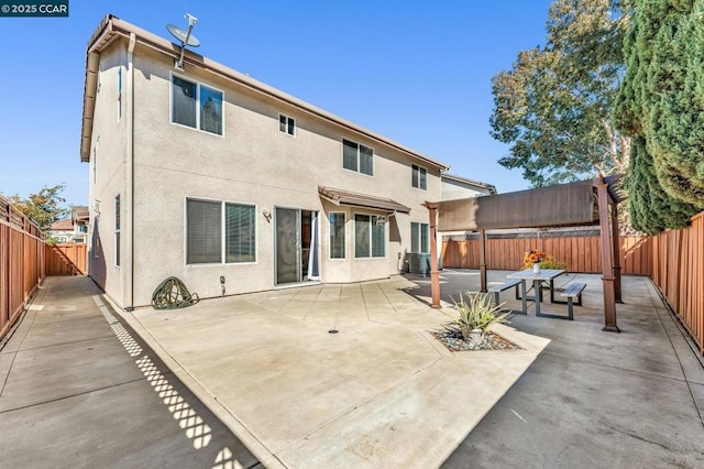 back of house with a patio