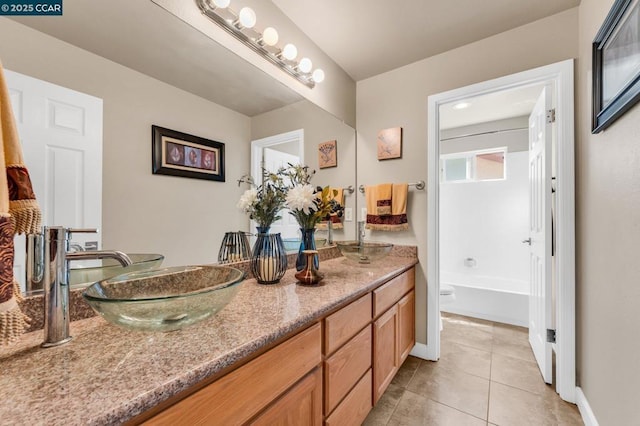 bathroom with vanity, shower / bath combination, and tile patterned flooring