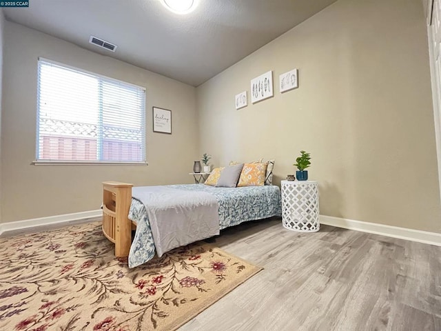 bedroom with hardwood / wood-style floors