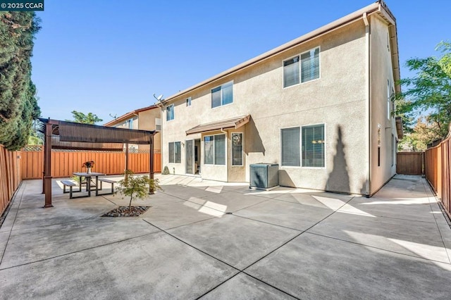 back of property featuring cooling unit and a patio