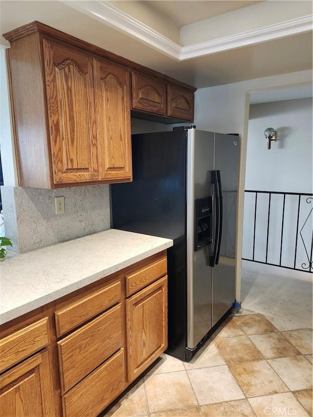 kitchen featuring decorative backsplash and stainless steel refrigerator with ice dispenser