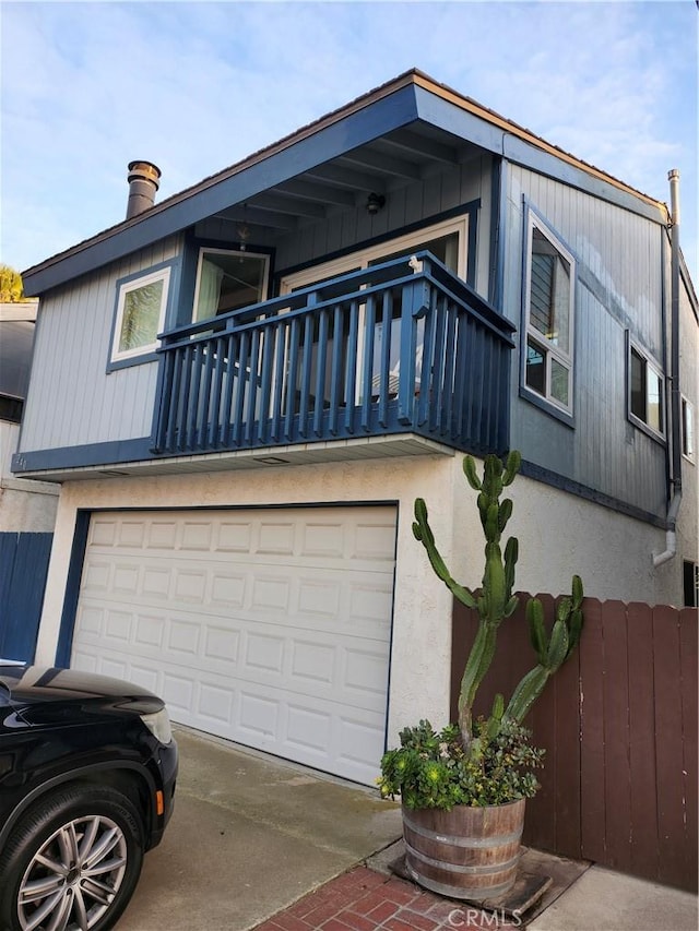 view of front of house with a garage and a balcony