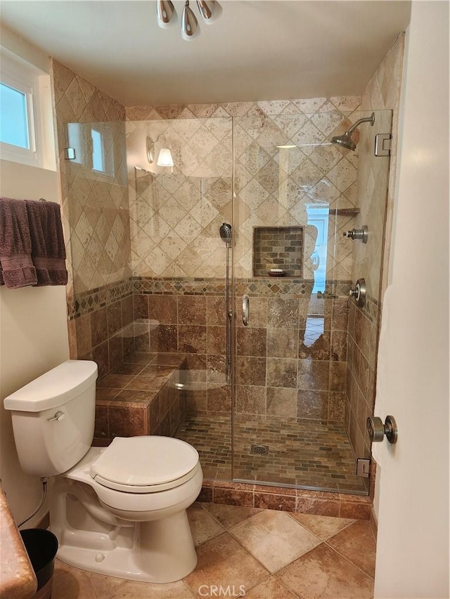 bathroom featuring walk in shower and toilet