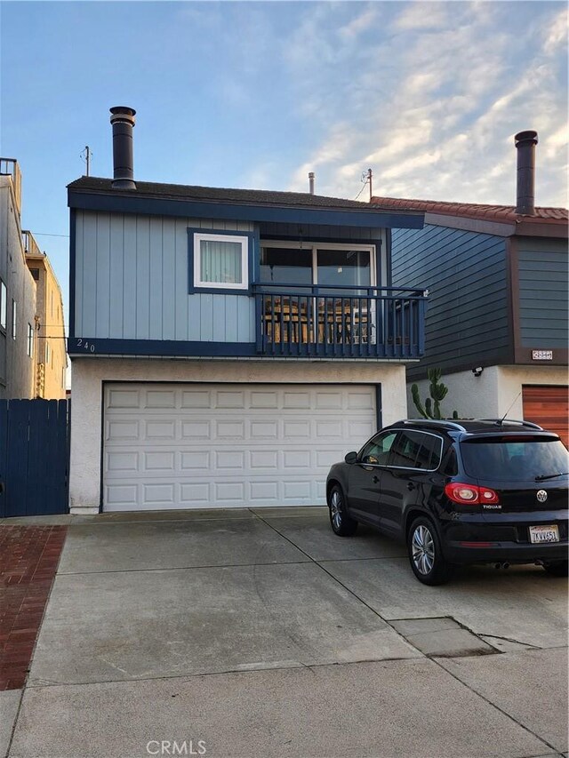 view of front facade with a garage and a balcony