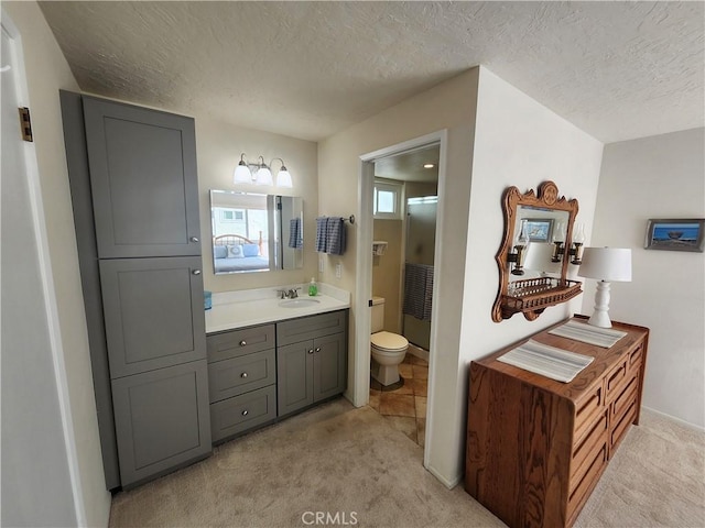 bathroom featuring vanity, a textured ceiling, and toilet