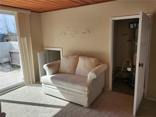 living area featuring wood ceiling and carpet flooring