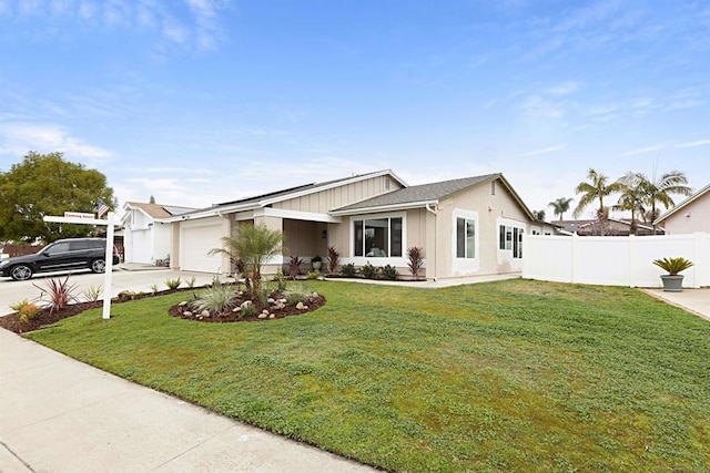 view of front of house featuring a garage and a front yard