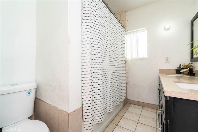 full bathroom featuring tile patterned floors, toilet, vanity, and shower / bath combo