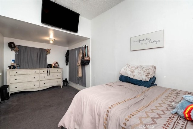 carpeted bedroom featuring a textured ceiling