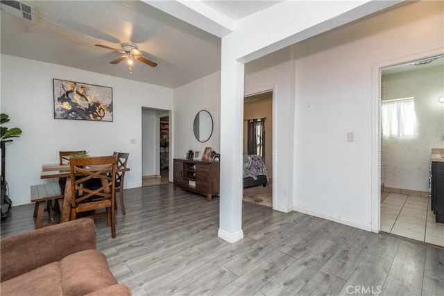 living room featuring ceiling fan and light wood-type flooring