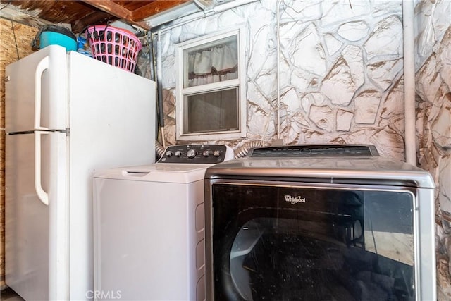 washroom with washing machine and clothes dryer