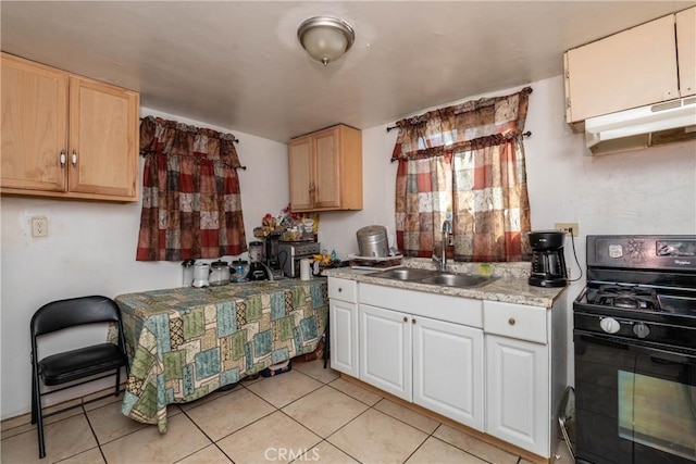 kitchen with light tile patterned floors, black range with gas cooktop, sink, and white cabinets