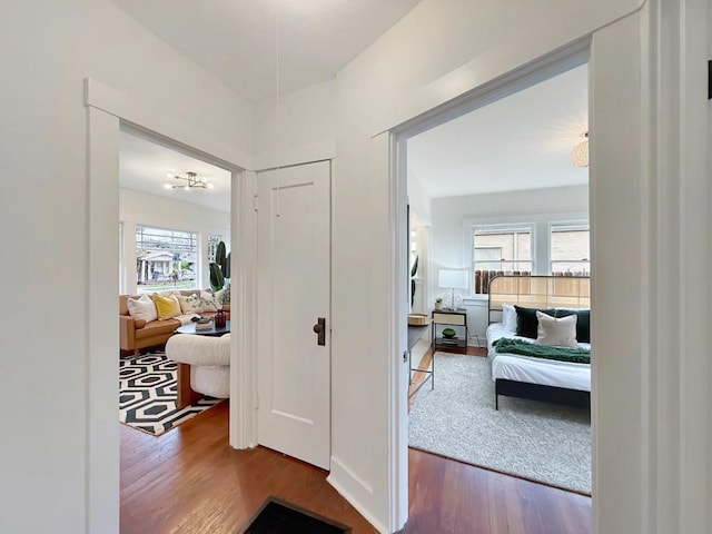 hallway with hardwood / wood-style flooring