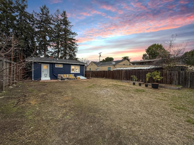 view of yard at dusk