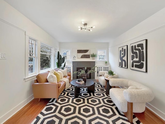 living room featuring a chandelier and light hardwood / wood-style floors