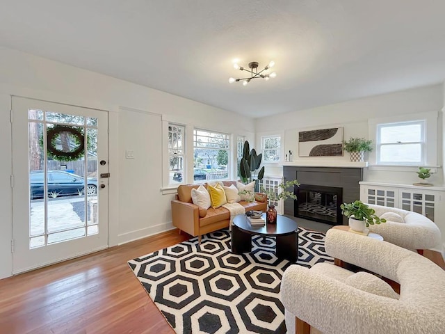 living room featuring a chandelier and light wood-type flooring