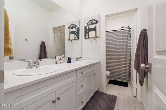 bathroom featuring walk in shower, vanity, toilet, and tile patterned flooring